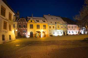 Fototapeta na wymiar Sighisoara Transylvania town night time scene of Clock Tower and main Square