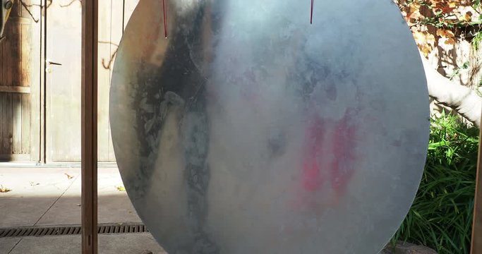a gong drum being hit with mallet