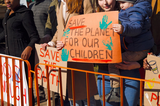 Child with mother with poster of protect environment