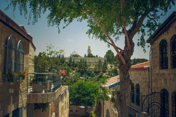 Fototapeta na wymiar Jerusalem ancient city street landmark UNESCO world heritage site in spring time with living building foreground and medieval palace background