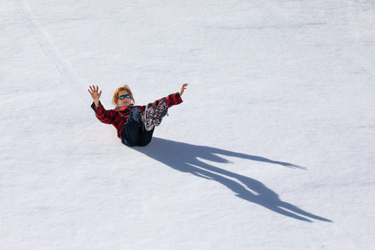 A boy sliding on the snow