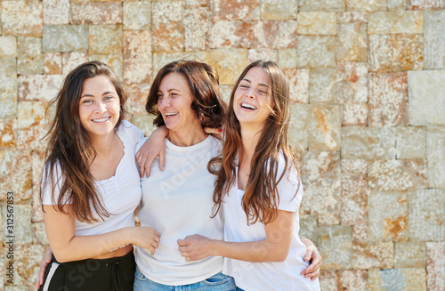 Embracing woman with young daughters