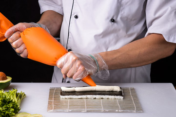 Chef cooks maki in stages