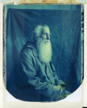 Bearded old man against drapery