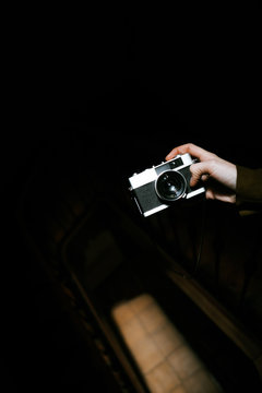 hand holding analog camera