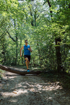 Man jumping over the obstacle on the run