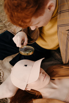 Young man looking through magnifying glass