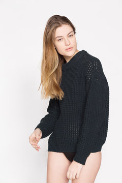 Young girl in a black sweater and sport shorts.
