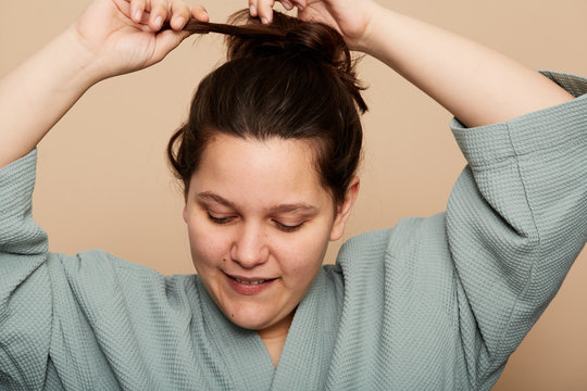 Woman undoing ponytail