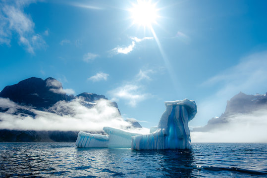 Glowing blue icebergs in sunlight