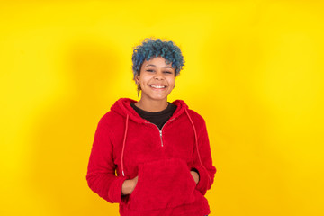 afro american girl with blue curl hair and casual style isolated on yellow background