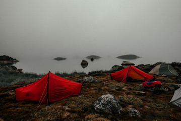 Camping tents on coast in thick fog