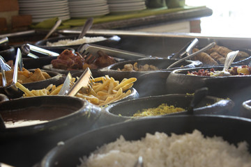 Free buffet at a self service restaurant, serve on a wood burning stove, with rice, fish, fries and...