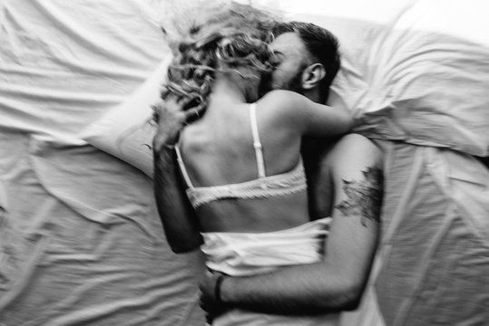 Couple in love kissing in bed