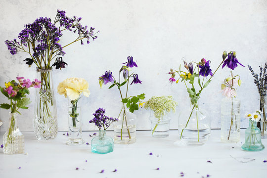 Wildflowers collected in glass vases and bottles