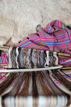 Lama wool on loom next to alpaca skin