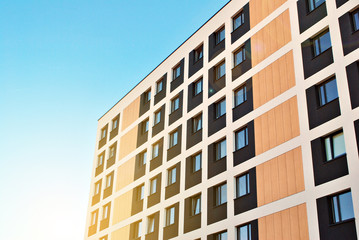 Sun rays light effects on urban buildings. Fragment of modern residential apartment with flat buildings exterior. Detail of new luxury house and home complex. 