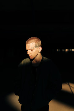Real Young Man in the shadow with sunlight on his face