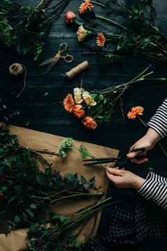 High Angle View Of Hands Cutting Flower While Arranging A Boquet