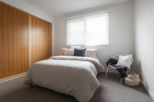 Bedroom with wood veneer robes