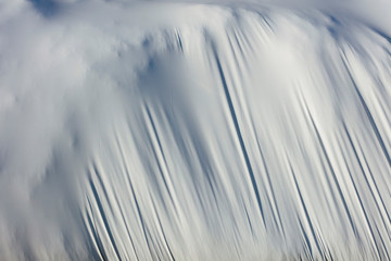 Detail of stretched white plastic tarp, focus on creases and folds