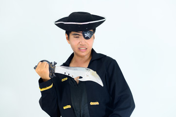 Young adult South East Asian wearing pirate costume with white background..