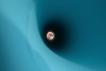 Anonymous female looking at camera through paper cone