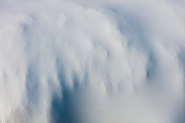 Detail of stretched white plastic tarp, focus on creases and folds