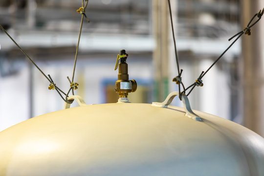 Compressed Industrial Big Air Gas White Cylinder Top, Installed With Steel Wire Rope, And Brass Valve, Selective Focus And Close Up View