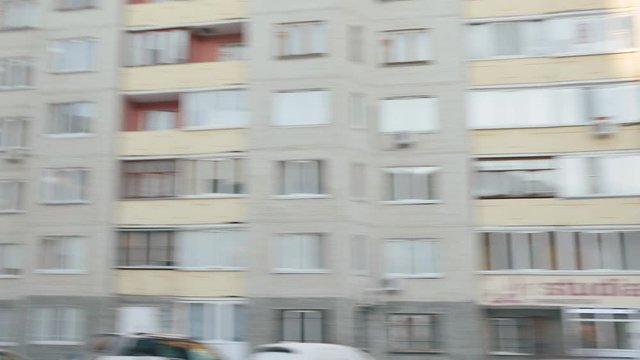 POV of rotating decent neighborhood block at winter day. Blurred motion of houses and colorful playground rotating at wintertime