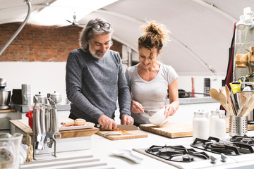 Affectionate couple together in the kitchen at home