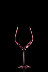 Red wine glass on the dark background.. Fine cristal glassware concept. Vertical