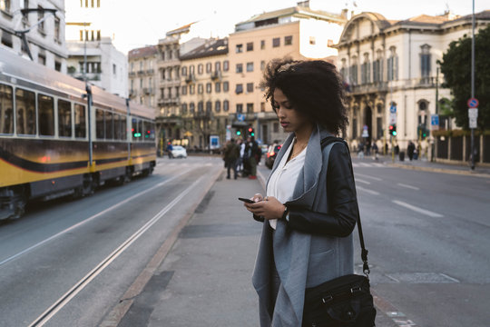 Young woman using a phone in the city