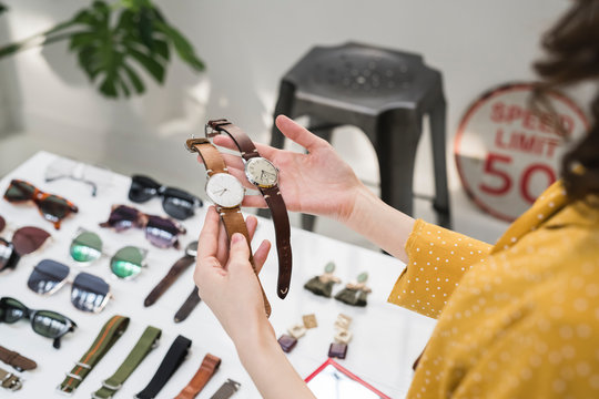 Young woman trying watches in a temporary store