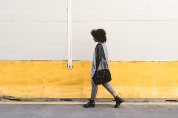 Beautiful young woman walking in the street