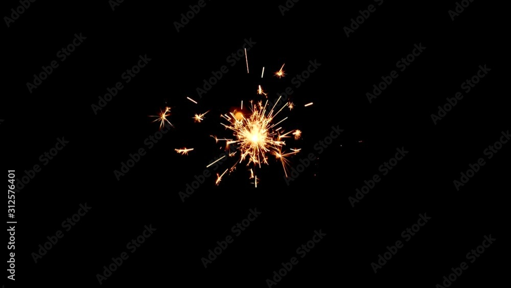 Poster static shot of a yellow and orange sparkler from above with a black background.