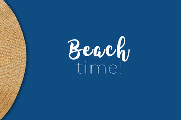 Overhead view of straw hat detail on the classic blue background with Beach time wording