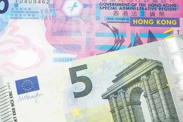A colorful ten dollar bill from Hong Kong shot in macro with a blue and green, European Union, five euro bill