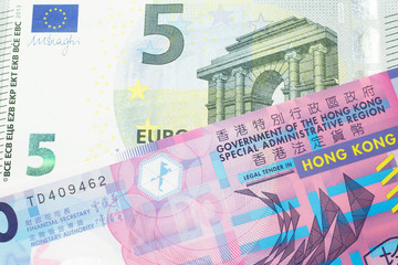 A colorful ten dollar bill from Hong Kong shot in macro with a blue and green, European Union, five euro bill