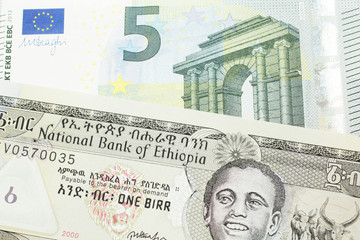 A one birr note from Ethiopia in macro with a five Euro European bank note close up