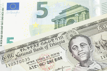 A one birr note from Ethiopia in macro with a five Euro European bank note close up