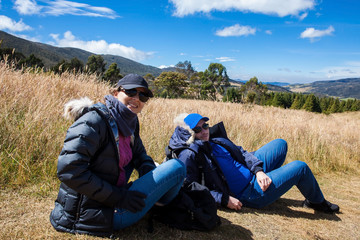 Naklejka na ściany i meble Young couple exploring nature at a beautiful paramo at the department of Cundinamarca in Colombia