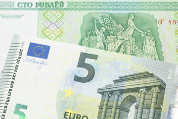 A close up image of a five Euro note from the European Union eurozone with a one hundred ruble note from Belarus