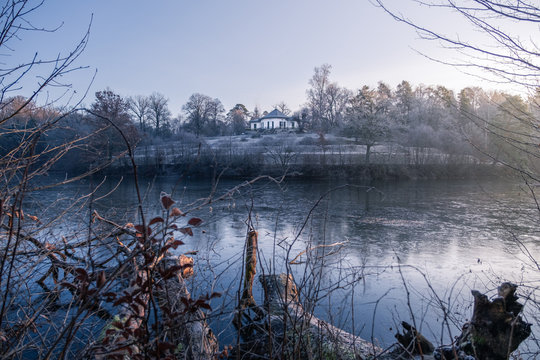 Atmospheric view on the "B&auml;renschl&ouml;ssle" and the frozen lake "Pfaffensee" at sunrise &mdash; Stuttgart, Germany