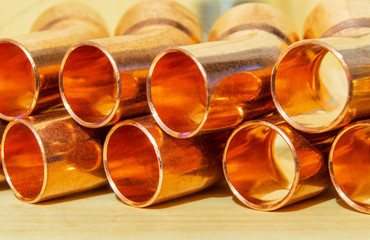 Set of copper pipes of the same diameter lying in one heap