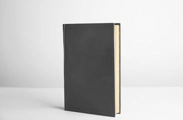Hardcover book on white background. Space for design