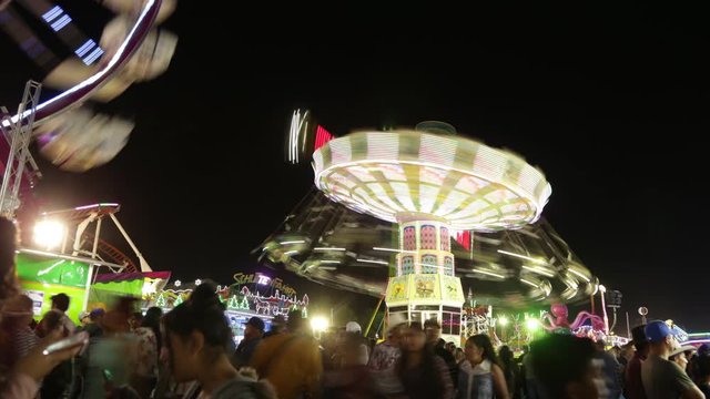 Aguascalientes, Mexico. 12/12/2019. Time lapse night video of Mechanical games of the national fair of San Marcos people having fun.