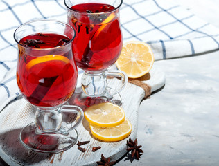 Fragrant, hot mulled wine with a slice of lemon, a cinnamon stick, anise star and clove bud.