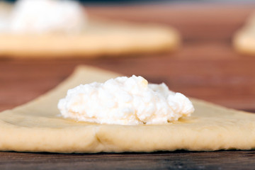 Preparation of the test for croissants. The dough is sliced in a triangle.