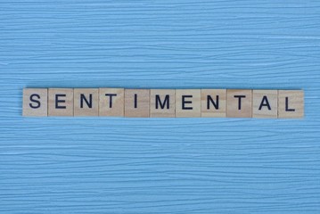word sentimental from small wooden letters on a blue table